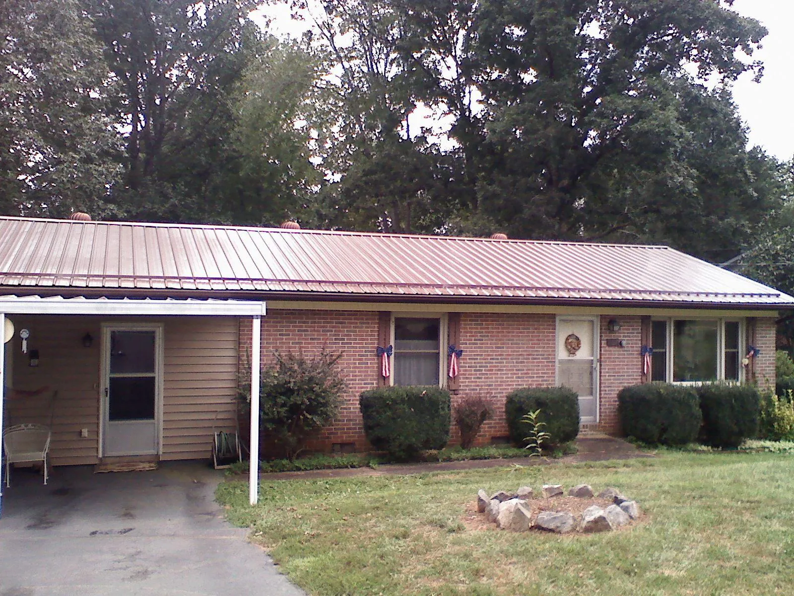 Bronze metal roof and carport on a brick ranch home — Roof Repair work by our crew in Royersford